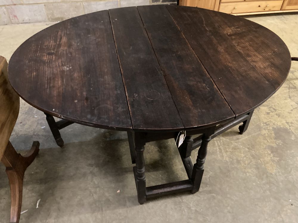 A late 17th century oak oval topped gateleg dining table, 140cm extended depth 114cm height 73cm
